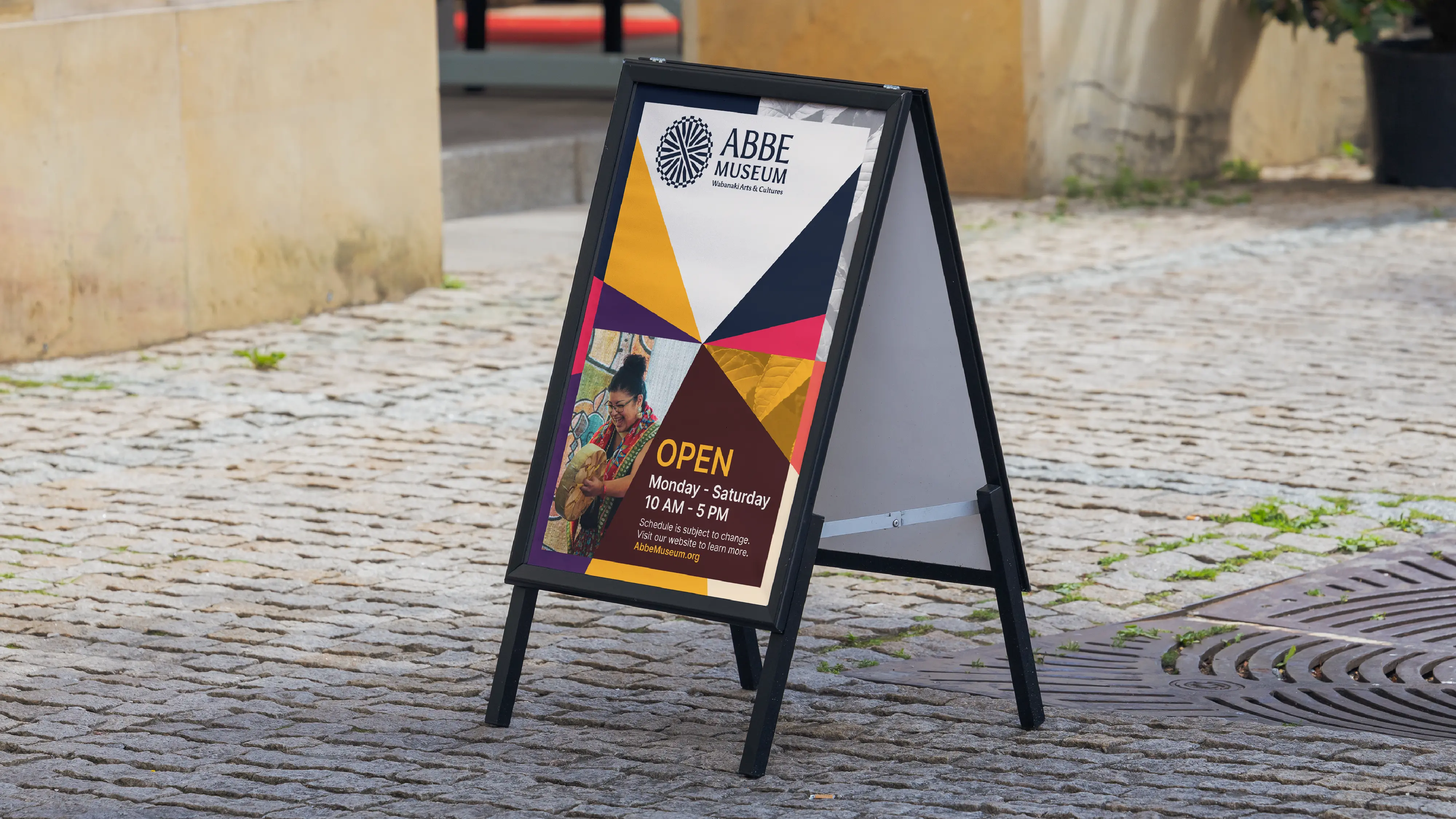 Abbe Museum new brand design in use - outdoor sandwich board hours / temporary and hours on-street sign with primary warm color palette in use. Brand redesign by In-House International weareinhouse.com