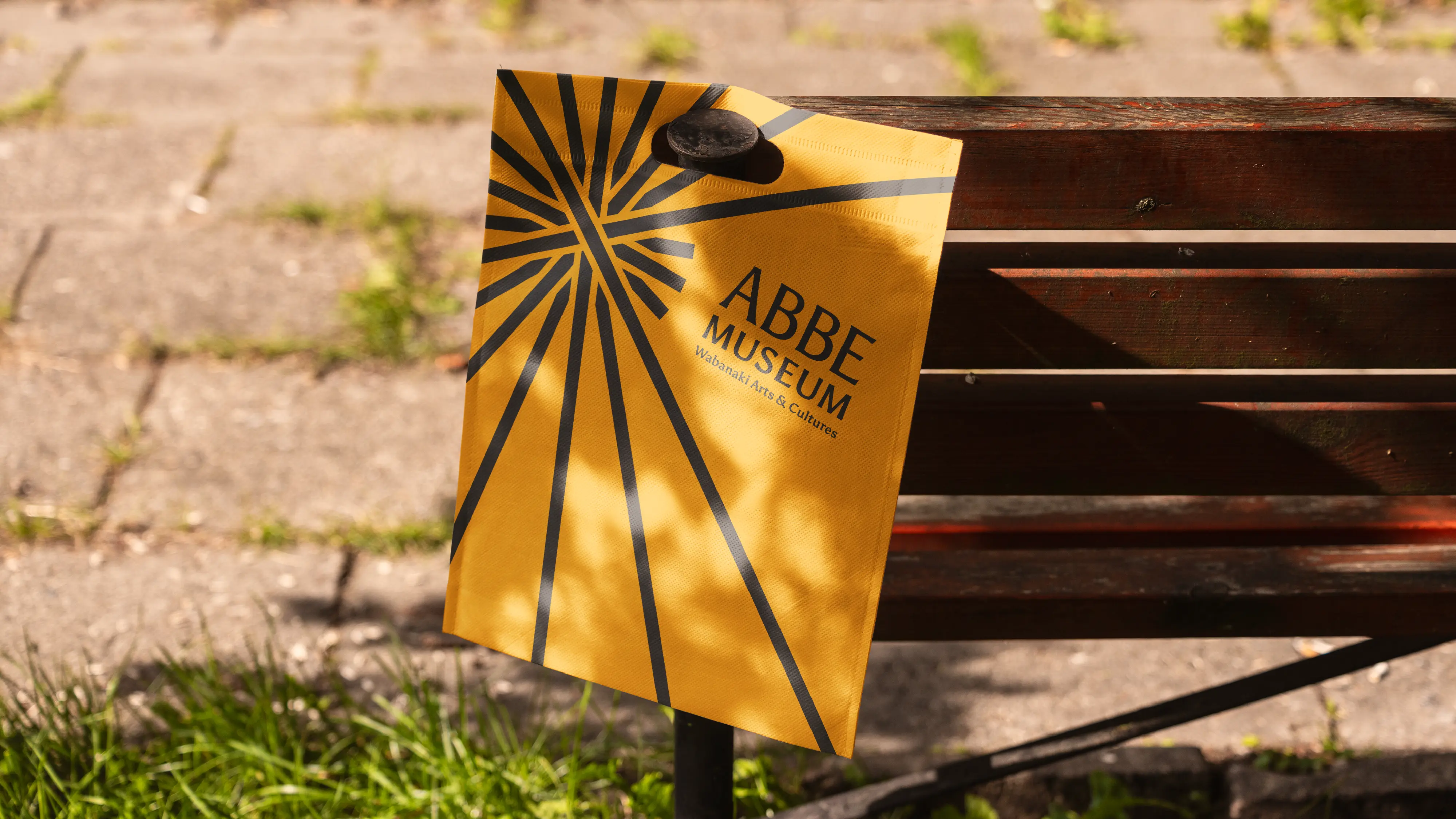 Abbe Museum brand redesign in use: graphic logo and logotype small shopping bag mock-up with tag line. Brand identity design by In-House International  weareinhouse.com