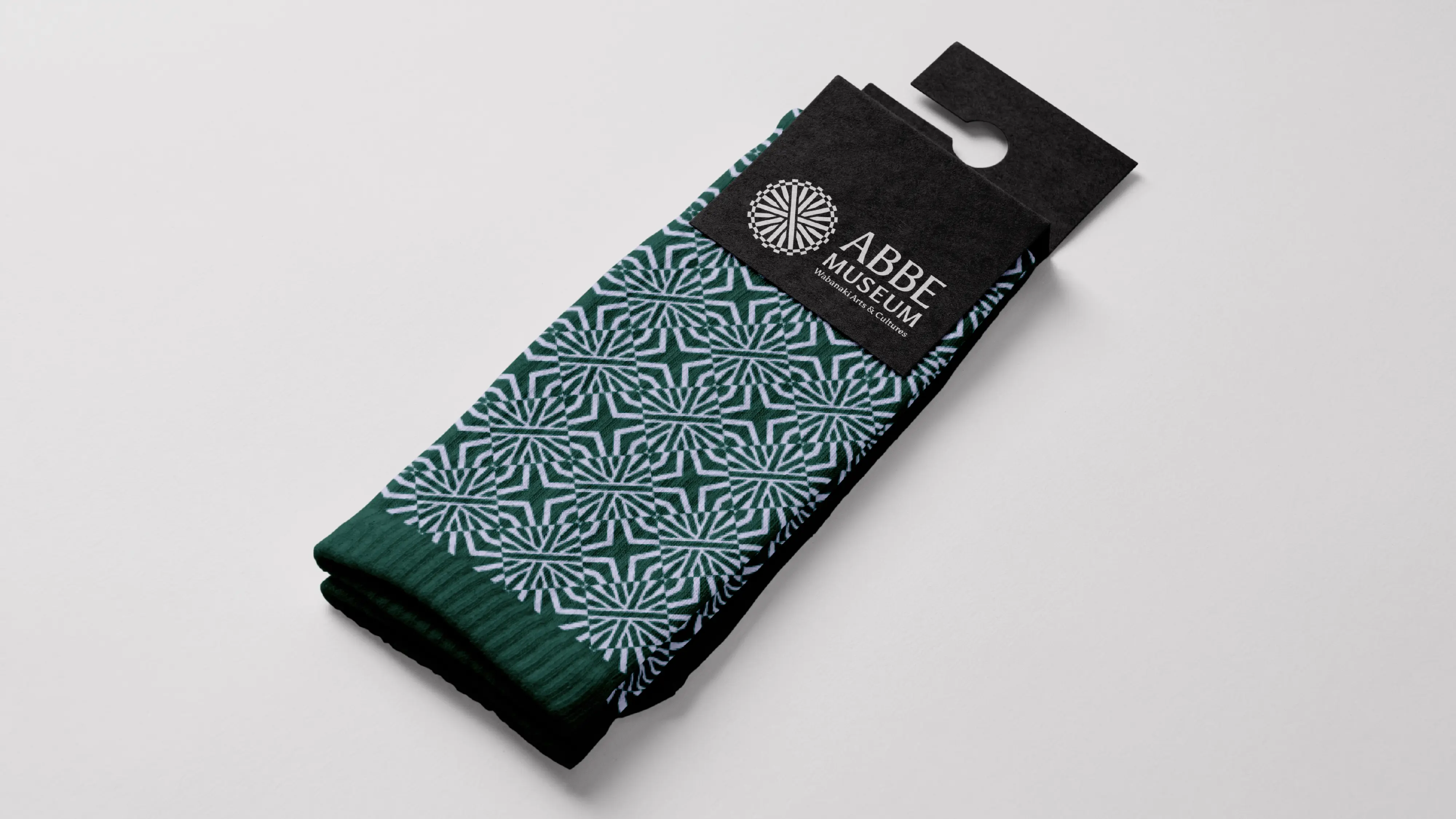 Abbe Museum brand redesign in use: graphic pattern socks. Brand identity design by In-House International  weareinhouse.com