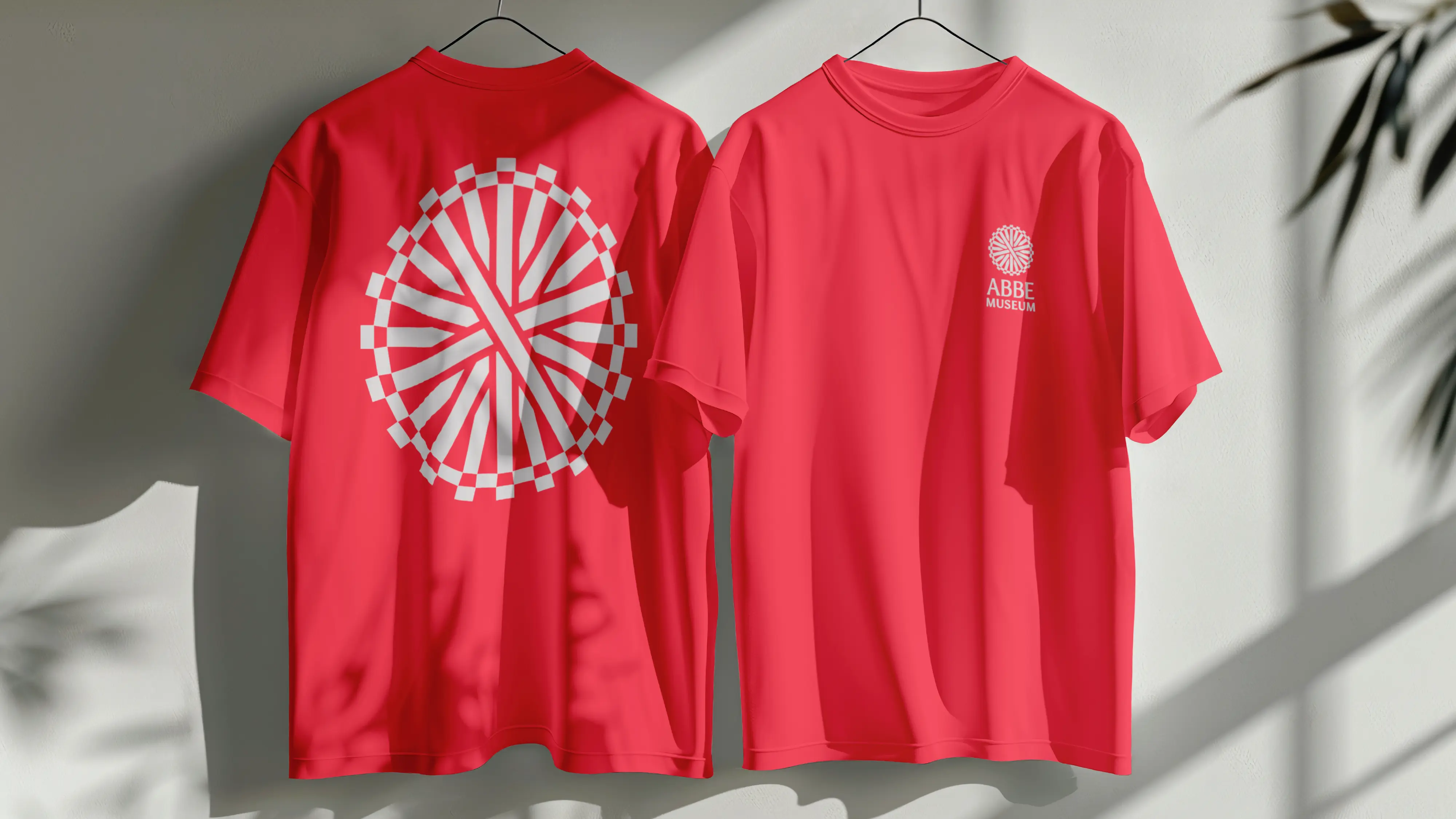Abbe Museum brand redesign in use: graphic Abbe Museum Logo color t-shirt design with large icon back. Brand identity design by In-House International  weareinhouse.com