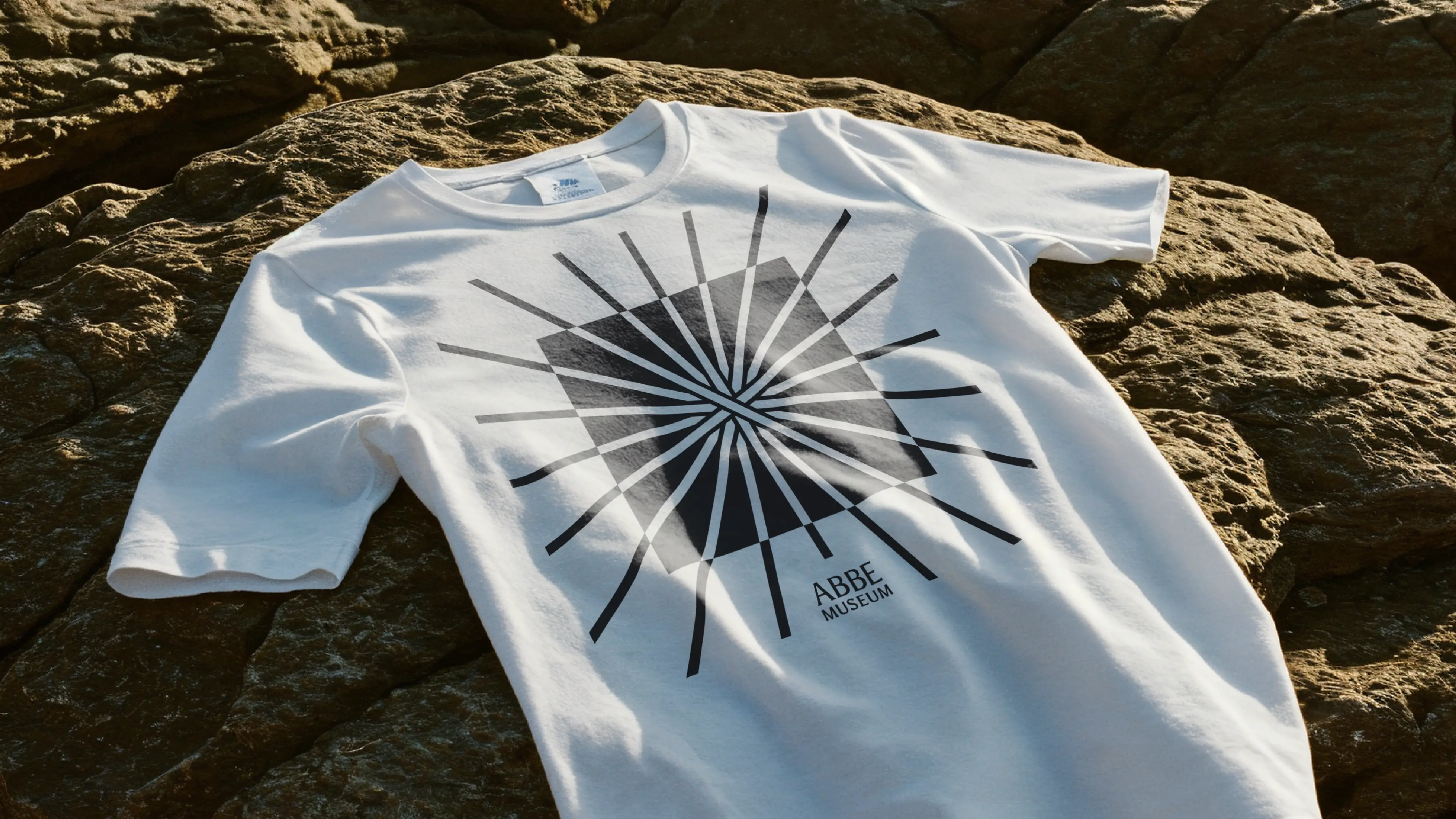 Abbe Museum brand redesign in use: graphic Abbe Museum Logo and name t-shirt design wordmark. Brand identity design by In-House International  weareinhouse.com